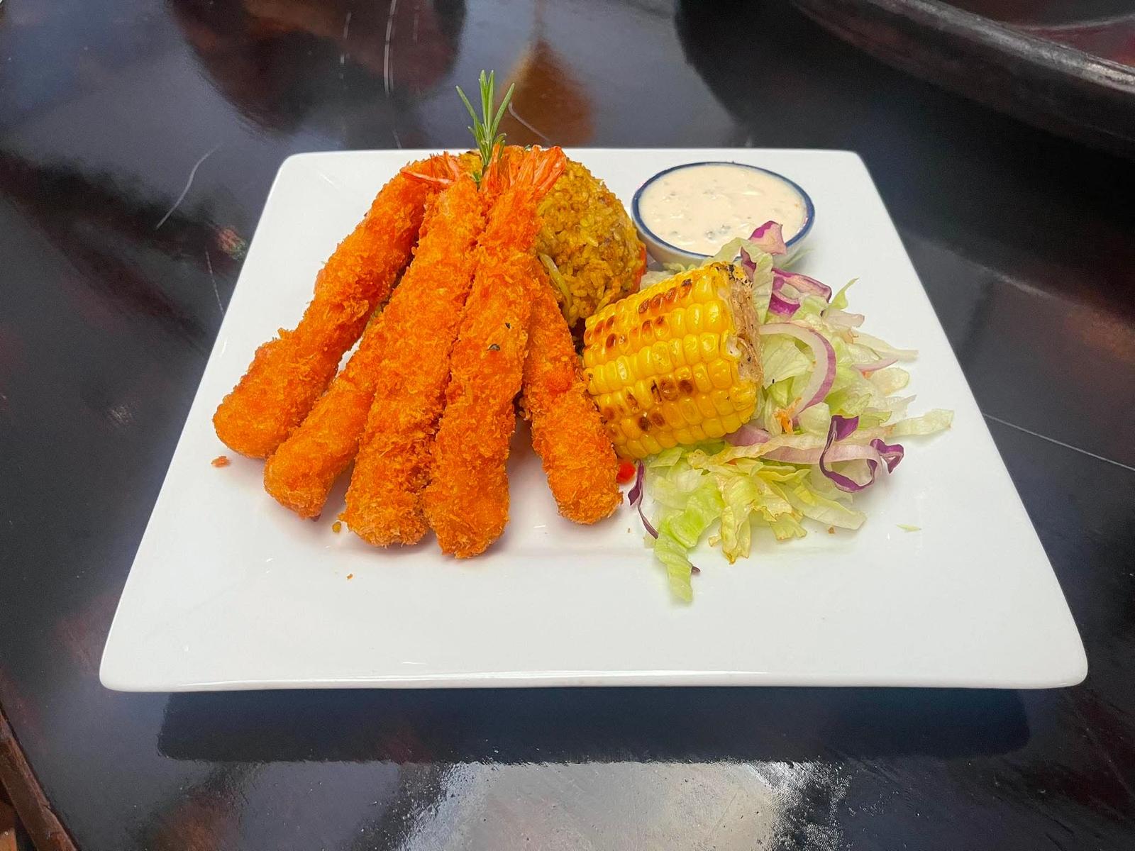 Crispy panko prawns with spiced rice and grilled corn
