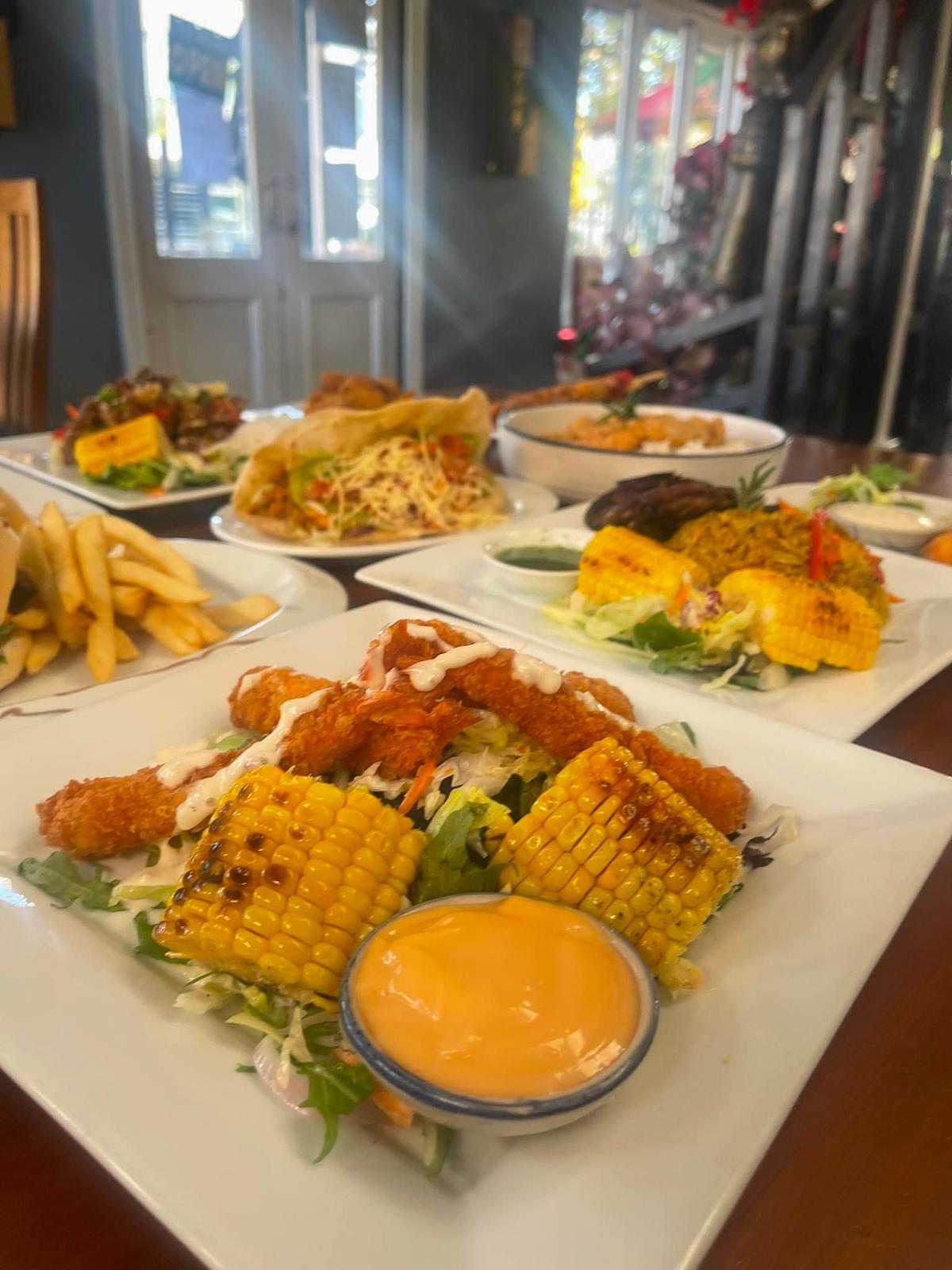Full table spread of Caribbean dishes