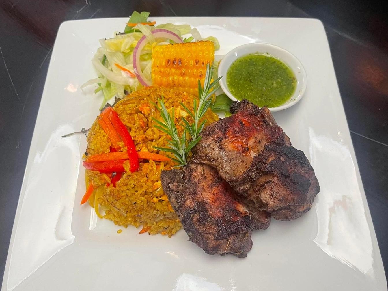 Jerk-style grilled chicken with spiced rice and grilled corn